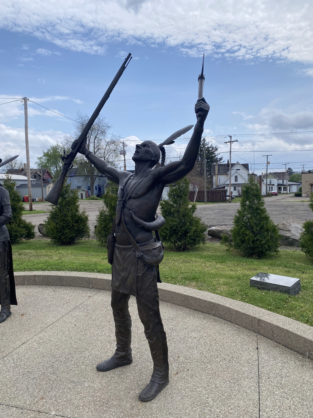 Bronze warrior statue raising arms to the sky