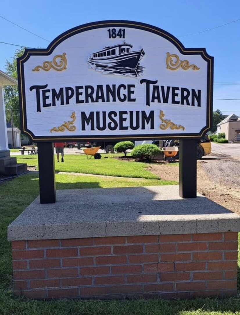 The 1841 Temperance Tavern Museum sign with a canal boat illustration