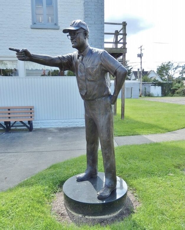Bronze statue of Woody Hayes pointing, in downtown Newcomerstown